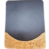 A mouse pad with a tooled pattern border on a white surface.