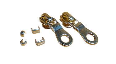A set of EVERBRIGHT brass zipper components including two zipper pulls, two bottom stops, and a set of top stops laid out on a white surface.