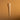 Clear plastic pipette on a brown textured background