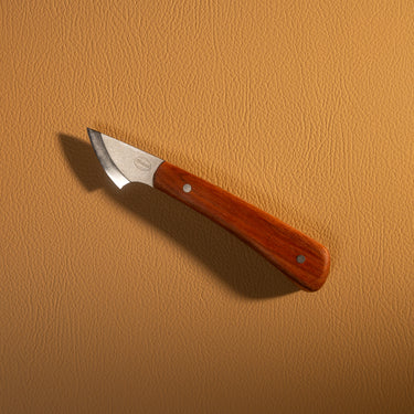 Knife with a wooden handle on a beige background