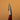 A `bleeder' tool, used for leather crafting and tooling. Laid out on a solid brown background.