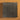 A collection of heavy duty staple refills laid out in a square pattern on a textured brown background.