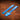A set of acrylic blue templates used for creating a custom pair of suspenders out of leather. Laid out on a textured brown leather background.