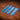 A set of blue acrylic templates used for creating custom strap ends in a western style for belts. Laid out on a textured brown leather background.