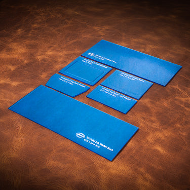 A set of blue acrylic templates for creating a custom "Tri-fold Bill" wallet. Laid out on a textured brown leather background.