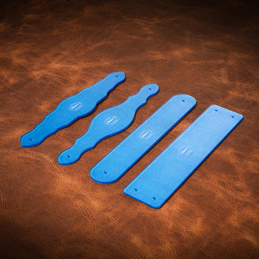 Four blue acrylic templates for creating straps on a brown leather surface