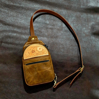 Finished 75% leather sling bag in brown Sepici bison with a floral tooled veg tan front pocket