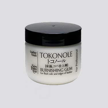 A container of TOKONOLE Leather Finish Burnishing Gum, primarily for flesh side and edges of leather, with text indicating it's for professional use.