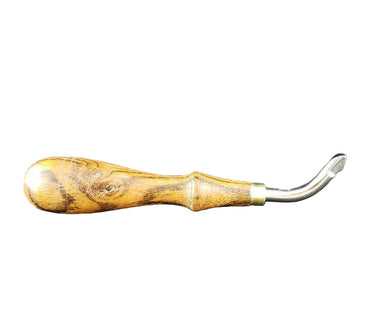 A handcrafted push beveler tool with a metal curved blade, and wooden handle used for beveling edges in leather crafting.