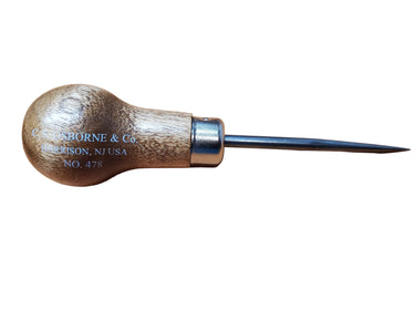 A sharp pointed scratch awl with a tempered blade and a wooden handle, lying on a flat white surface.