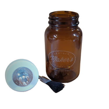 An 8oz amber-colored glass jar with a brush connected to the cap, displayed on a white surface.