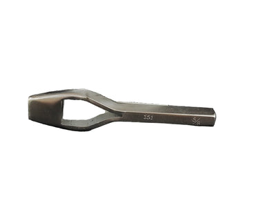 A metal bag punch tool resting on a white mug with 'Leather Maker's Supply' printed on it, against a black background.