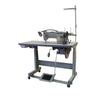 A gray Cobra Class 18 sewing machine on a flatbed stand with locking casters, equipped with a needle, spools, and a pedal.