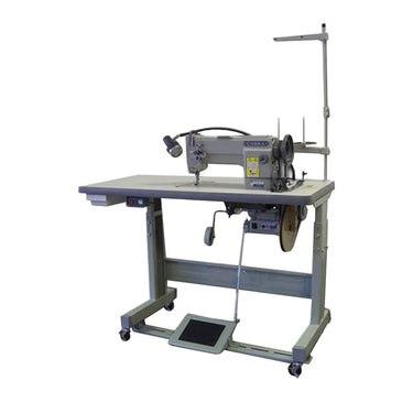 A gray Cobra Class 18 sewing machine on a flatbed stand with locking casters, equipped with a needle, spools, and a pedal.