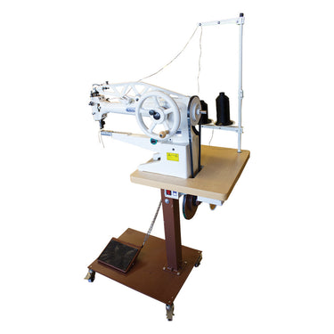 A Cobra Class 29-18 sewing machine mounted on a stand, with sewing accessories visible.