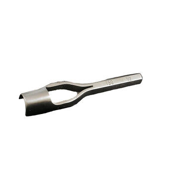A metal round end punch tool lying on a white surface