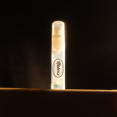 A marker branded with the logo Maker's Leather Supply, used for dying leather textiles and projects, laid out on a dark background. 