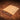 An acrylic leather stamp holder with holes and four small metal beams on a brown leather surface.